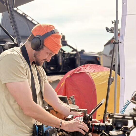 Johnny Harrington on set behind a camera
